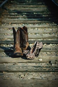 Shoes and high heels on railroad track