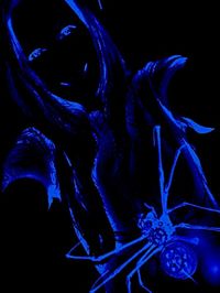 Close-up of blue light painting against black background