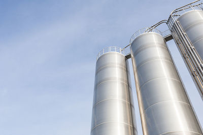 Low angle view of storage tank against sky