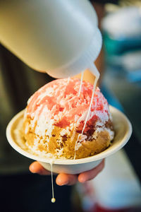 Close-up of hand holding ice cream cone