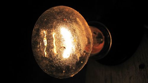 Close-up of lit light bulb