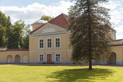 Lawn by building against sky