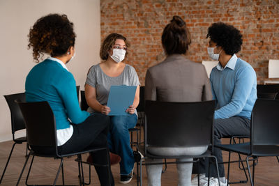 People discussing business activity in office