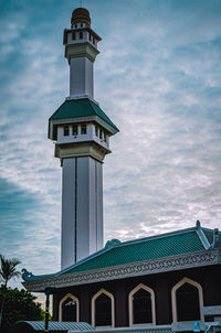 Low angle view of building against cloudy sky