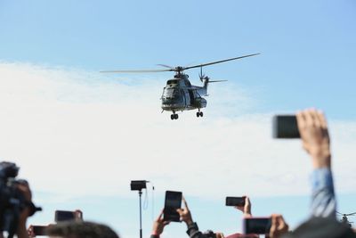 Low angle view of helicopter flying against sky