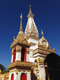 Low angle view of statue against blue sky