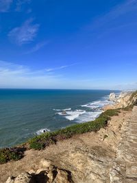 Scenic view of sea against blue sky