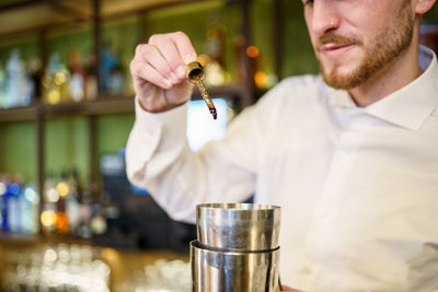 Young man drinking glass