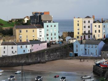High angle view of buildings by sea against sky