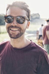 Portrait of man wearing sunglasses while standing outdoors