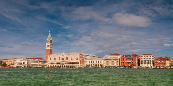 View of buildings against cloudy sky