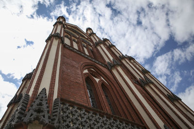 Low angle view of building against cloudy sky