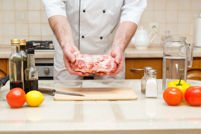 Low angle view of man preparing food in kitchen
