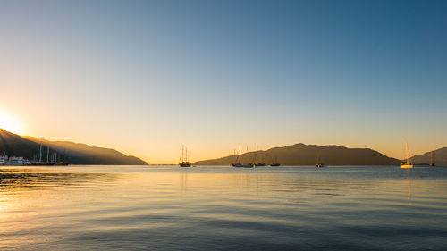 Scenic view of sea against clear sky during sunset