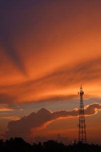 Low angle view of silhouette tower against romantic sky at sunset