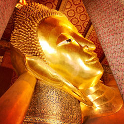 Close-up of buddha statue against building