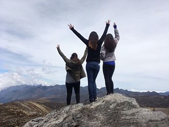 Full length of women standing on mountain against sky