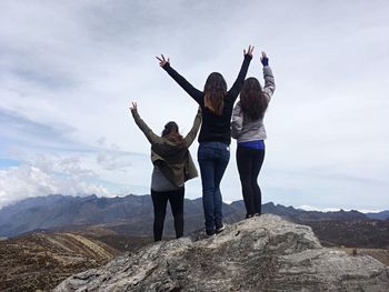 Full length of women standing on mountain against sky