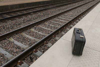 High angle view of suitcase on railroad station
