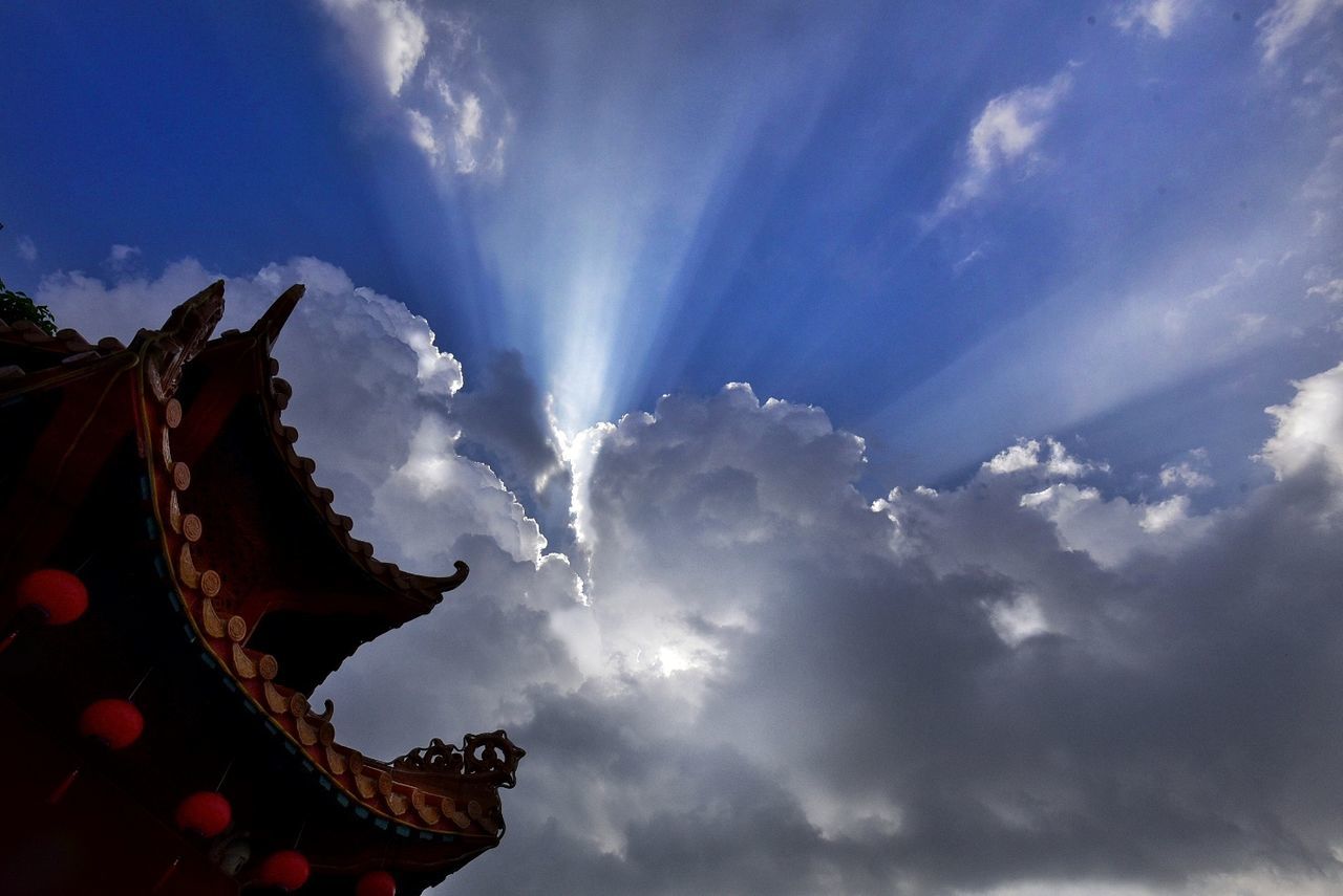 cloud - sky, sky, low angle view, sunbeam, religion, outdoors, no people, day, spirituality, sunlight, nature, sculpture, statue, beauty in nature, sun, built structure, building exterior, place of worship, architecture