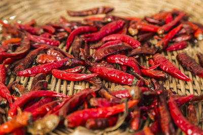 Close-up of red chili peppers in wicker basket