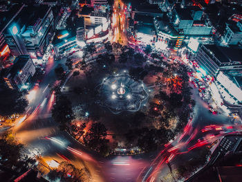 High angle view of illuminated city street and buildings at night