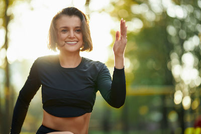 Portrait of smiling young woman standing outdoors