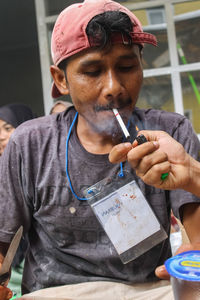 Young man smoking cigarette