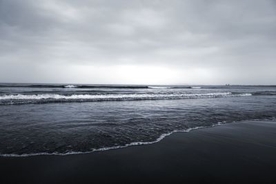 Scenic view of sea against cloudy sky