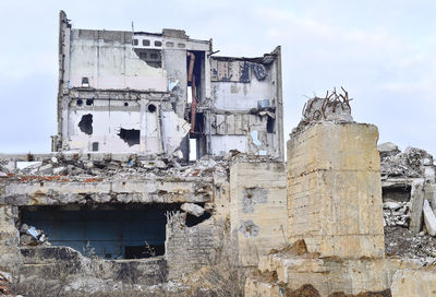 Damaged building against sky