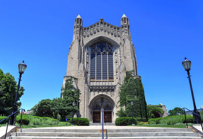 Low angle view of building against clear blue sky