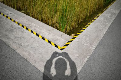 High angle view of arrow sign on road