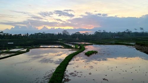 Scenic view of lake against cloudy sky