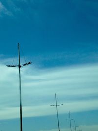 Low angle view of windmill against blue sky