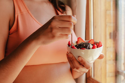 Midsection of woman holding ice cream