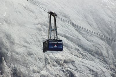 Overhead cable car covered with snow