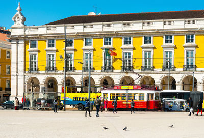 People by cable car at praca do comercio in city