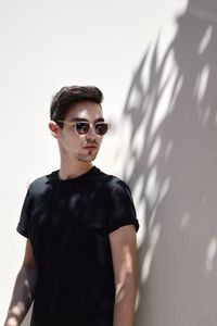 Young man wearing sunglasses standing outdoors