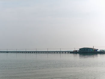 Bridge over sea against sky