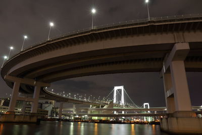 Low angle view of illuminated bridge at night