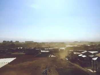 High angle view of houses in town against clear sky