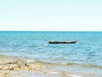 Boat in sea against sky