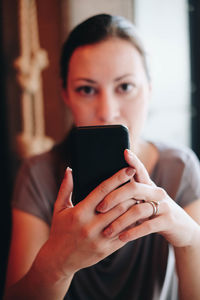 Woman using mobile phone in home