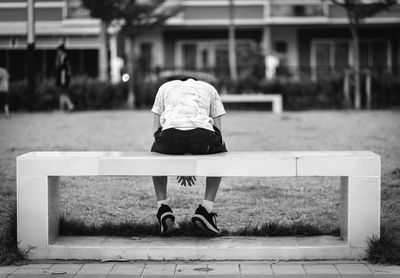 Rear view of man and woman on bench