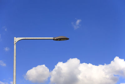 Low angle view of security camera against sky