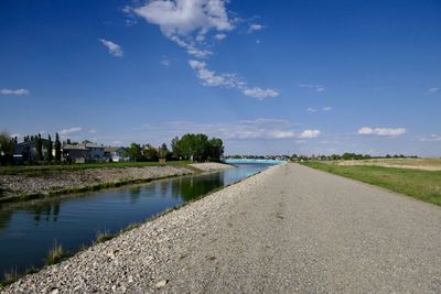 Scenic view of river by city against sky
