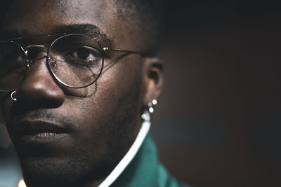 Close-up portrait of young man looking away