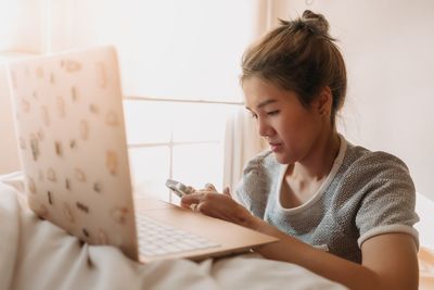 Young woman using laptop at home