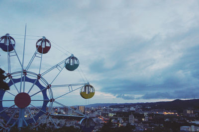 Ferris wheel in city against sky