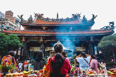 Group of people in temple outside building